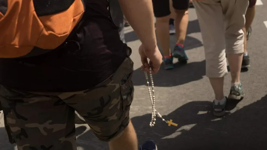 Imagem moco caminhando rezando o terco do artigo Terço: oração repetitiva e cansativa?