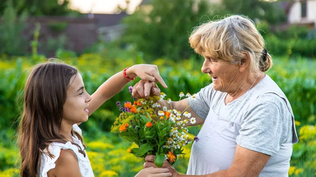 Imagem Uma menina crianca entregando flores a uma idosa do artigo Você sabe ser gentil? Aprenda com a Bíblia!