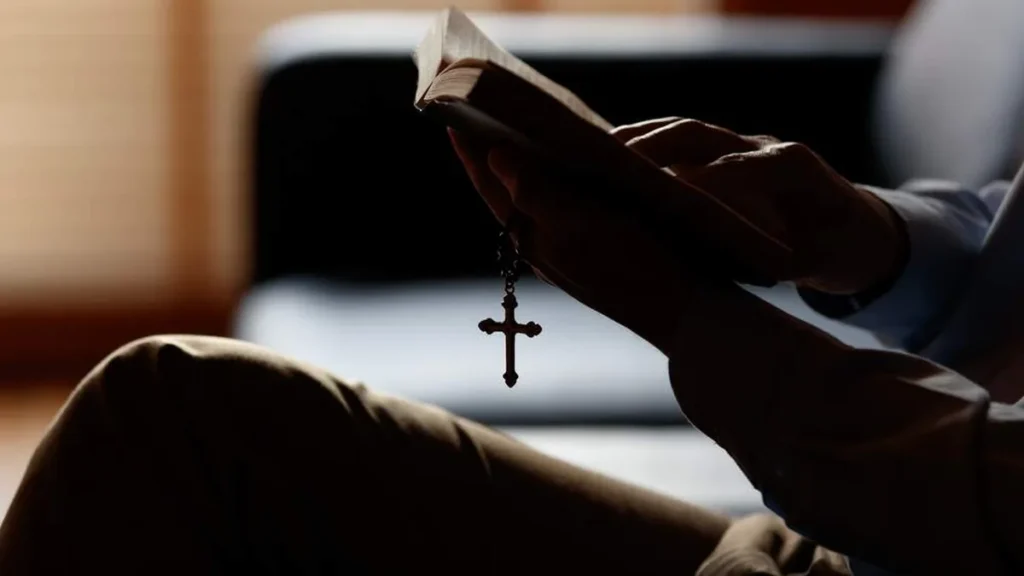 Imagem pessoa segurando biblia com crucifixo do artigo Ato de Contrição