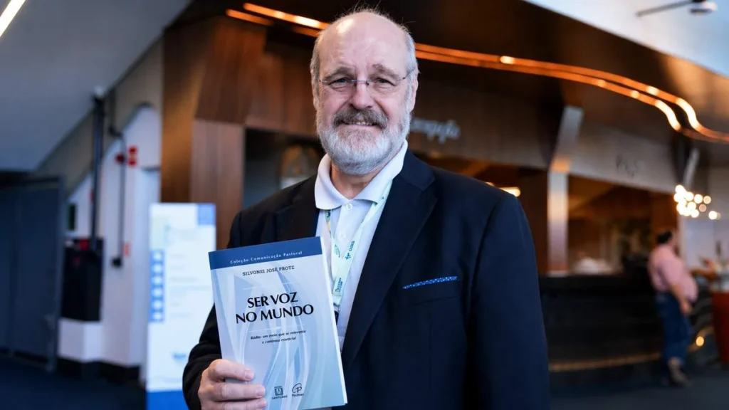 Imagem silvonei jose durante 62 assembleia geral da cnbb com seu livro ser voz no mundo do artigo "Ser Voz no Mundo": livro de Silvonei José reafirma missão do rádio