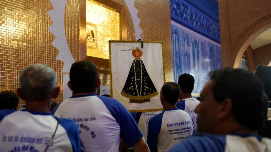 Imagem romeiros diante do nicho de nossa senhora aparecida do artigo No encerramento do Mês Mariano, Aparecida acolhe diversidade de peregrinações